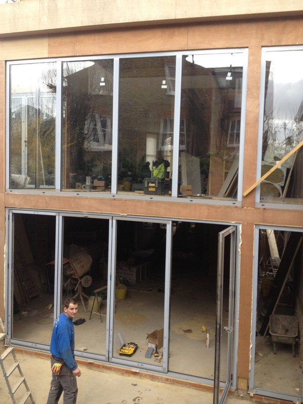 Aluminium bi-fold doors with two-storey glazing in Plaistow