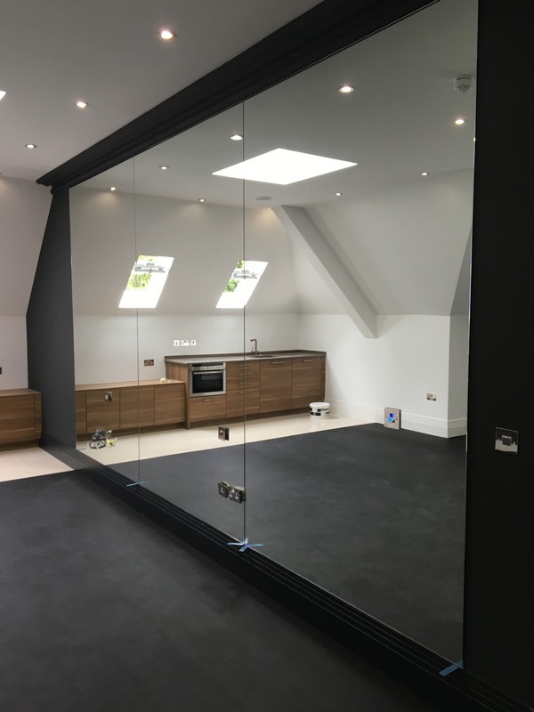 Frameless glass partition in loft conversion by Plaistow glaziers
